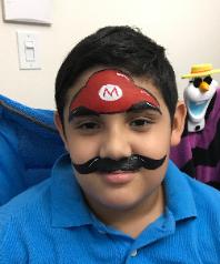 Full face painting done by a qualified artist at your child's birthday party like this Super Mario Brothers painting.