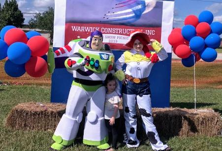 Party characters for kids in Houston at Warwick construction picnic by Wings over texas airshow with mascot cowgirl toy and mascot toy astronaut in Clearlake