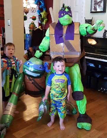 Hire a Donatello Ninja Turtle superhero mascot costumed character for a birthday party in Houston, Texas.